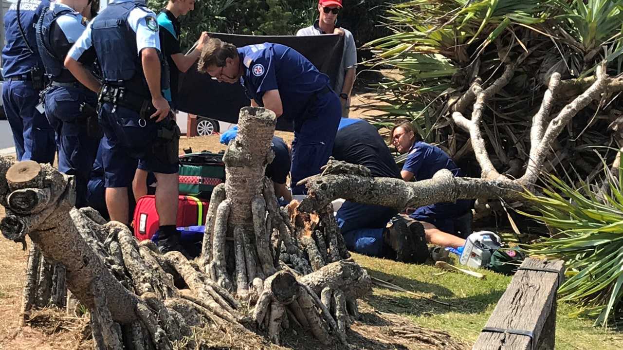 Emergency services at the scene at Lennox Head, where a tree has fallen on a man. Picture: Mitchell Craig