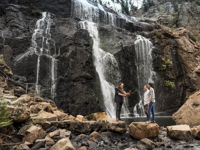 Winter is the season for chasing waterfalls. A tour group at McKenzie Falls. Picture: Tourism Victoria