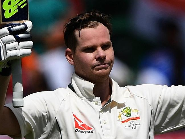 Australia's captain Steve Smith raises the bat and helmet as he celebrates after scoring a century (100 runs) during the fourth and last Test cricket match between India and Australia at The Himachal Pradesh Cricket Association Stadium in Dharamsala on March 25, 2017. ----IMAGE RESTRICTED TO EDITORIAL USE - STRICTLY NO COMMERCIAL USE----- / GETTYOUT---- / AFP PHOTO / PRAKASH SINGH / ----IMAGE RESTRICTED TO EDITORIAL USE - STRICTLY NO COMMERCIAL USE----- / GETTYOUT