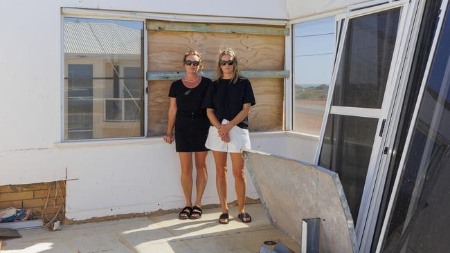 Nova Burges and Hailey Ralph in their wrecked Kalbarri home. Picture: Graeme Gibbons