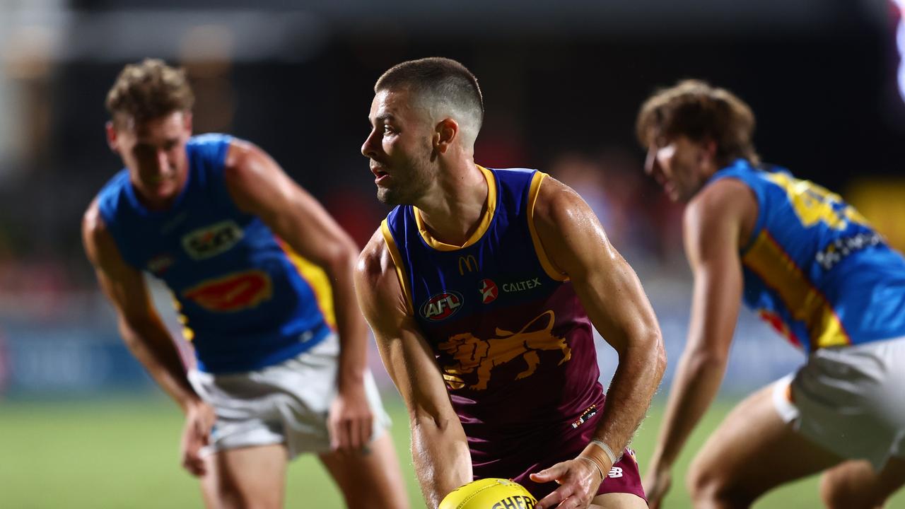 Josh Dunkley looks to offload the ball during Brisbane’s pre-season win over the Gold Coast. Picture: Chris Hyde/Getty Images