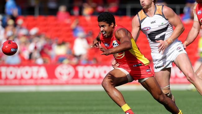 Joel Wilkinson hunts possession during his AFL career with Gold Coast.