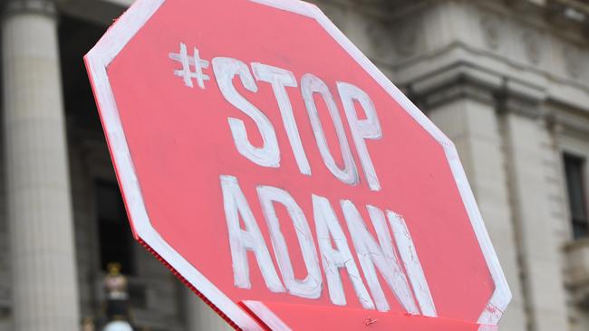 An anti-Adani placard is held by a protester. Picture: AAP Image/James Ross.