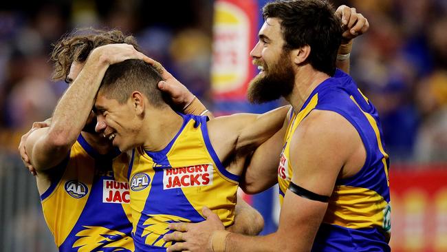 Charlie Cameron’s younger brother Jarrod (centre) is congratulated by teammates after scoring a goal on debut for West Coast against Essendon. Picture: Will Russell/AFL Photos