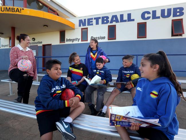 20/09/2018 Kylie Briggs with Caleb Nicholson, 8 , Jarris, Tass,10, Tallara Saunders, 12, Mason Nicholson, 6, Ngtaeo Tass, 10, and Miah Saunders,10 .  They are part of the Rumabalara netball and footy club in Shepparton, Victoria running a program linking sport with homework, and gets kids to do homework first before they head to footy and netball training.Picture : David Geraghty / The Australian.