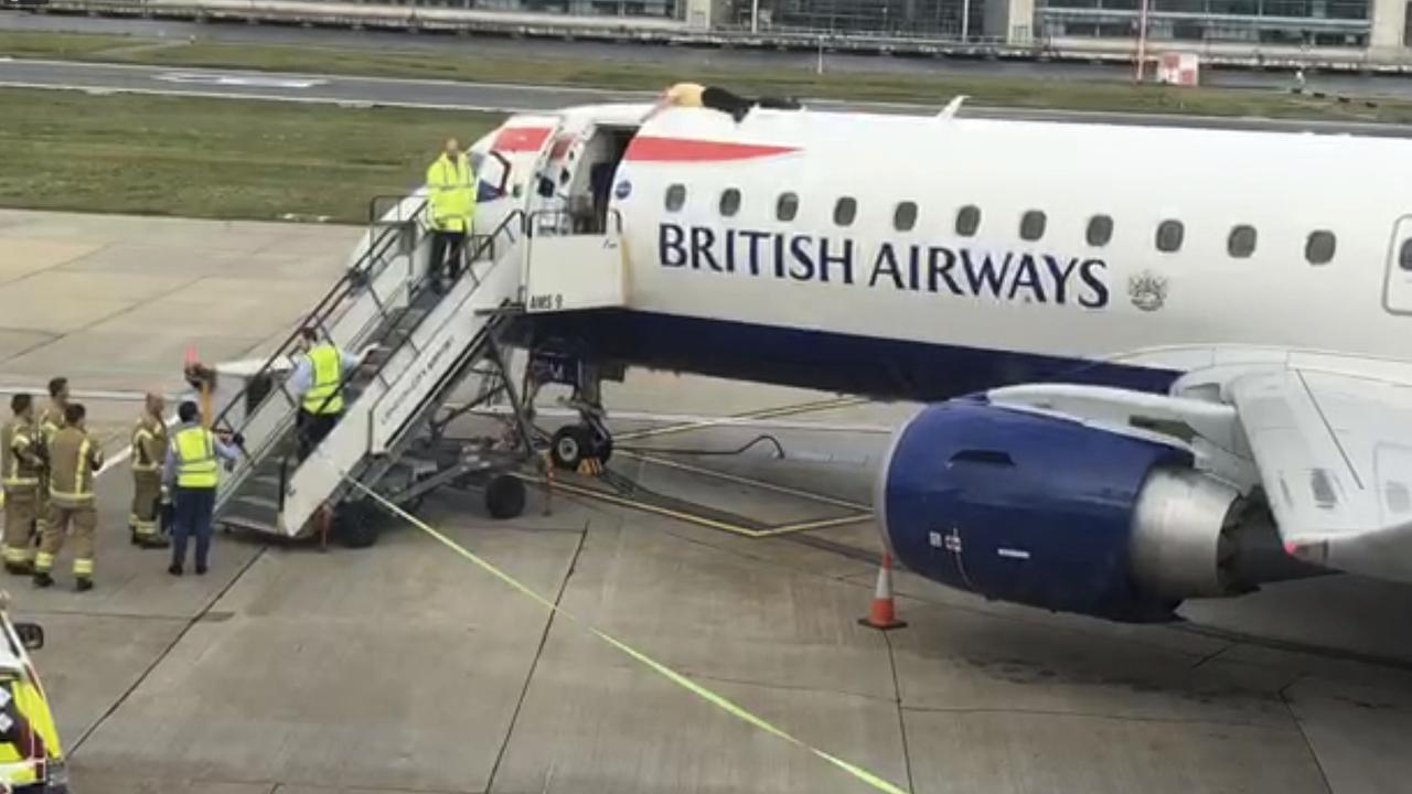 James Brown lying on top of a British Airways plane at City Airport. Picture: Extinction Rebellion via AP