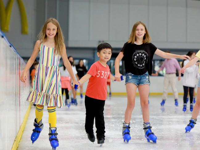 Arabella Hayes 10, Sabina McIvor 10, and Ethan Sun, 6, were among the hundreds of people who laced up the skates at Macquarie Ice Rink today. (AAP IMAGE/ Angelo Velardo)