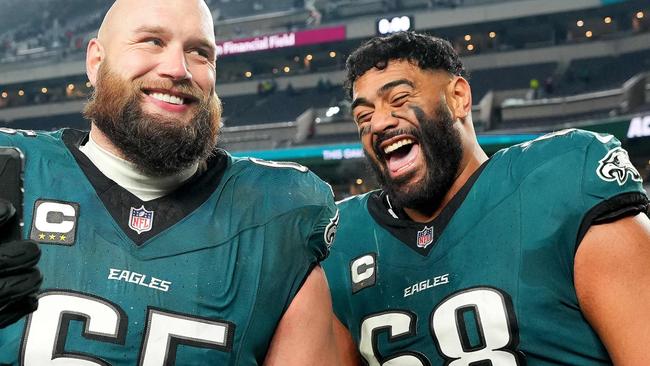 PHILADELPHIA, PENNSYLVANIA - JANUARY 12: Lane Johnson #65 and Jordan Mailata #68 of the Philadelphia Eagles celebrate beating the Green Bay Packers 22-10 during the NFC Wild Card Playoff at Lincoln Financial Field on January 12, 2025 in Philadelphia, Pennsylvania.   Mitchell Leff/Getty Images/AFP (Photo by Mitchell Leff / GETTY IMAGES NORTH AMERICA / Getty Images via AFP)