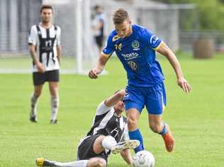 UNDER PRESSURE: Willowburn's Peter Millican slides in on USQ's Daniel Fuller. Picture: Nev Madsen