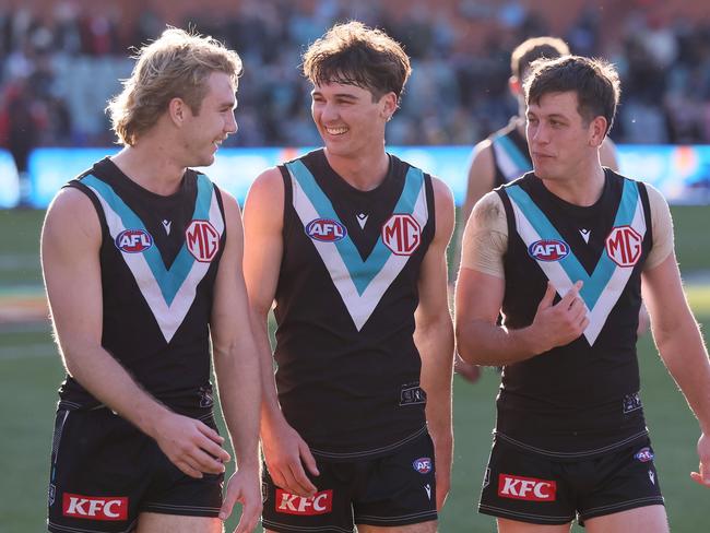 ADELAIDE, AUSTRALIA – JULY 06: Jason Horne-Francis, Connor Rozee and Zak Butters of the Power celebrate their win during the 2024 AFL Round 17 match between the Port Adelaide Power and the Western Bulldogs at Adelaide Oval on July 05, 2024 in Adelaide, Australia. (Photo by James Elsby/AFL Photos via Getty Images)