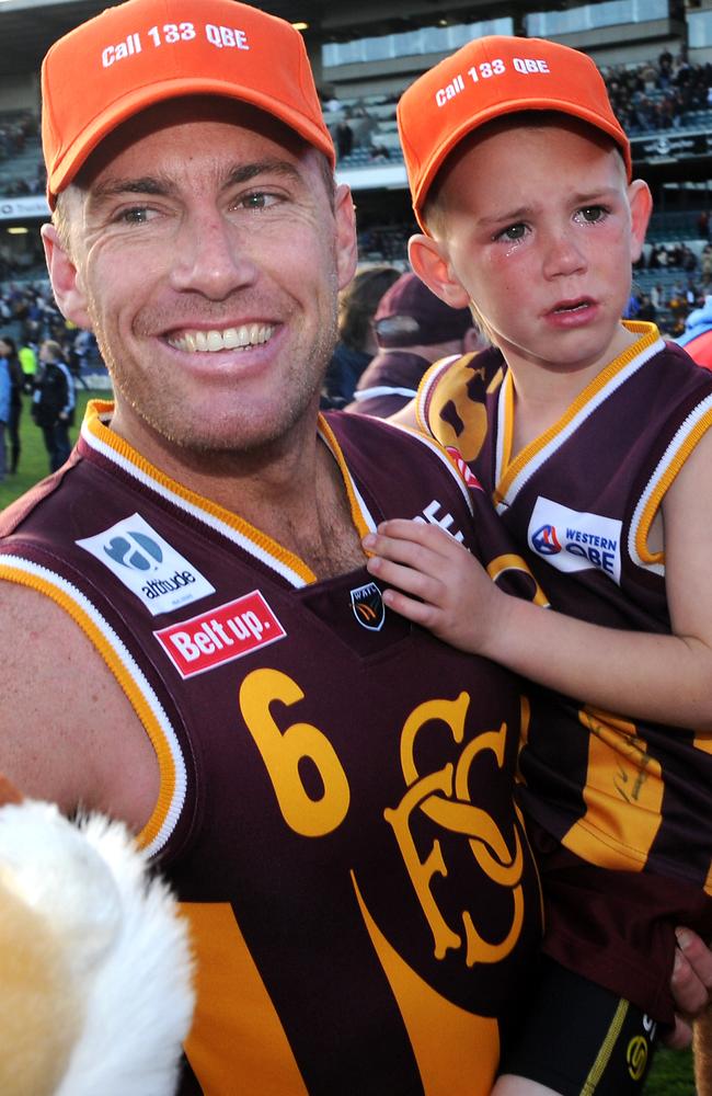 Subiaco’s Jarrad Schofield and son Taj after the grand final victory.