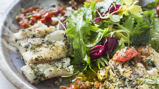 Roast thyme crusted fillet of fish with warm shallot dressing and herb salad.