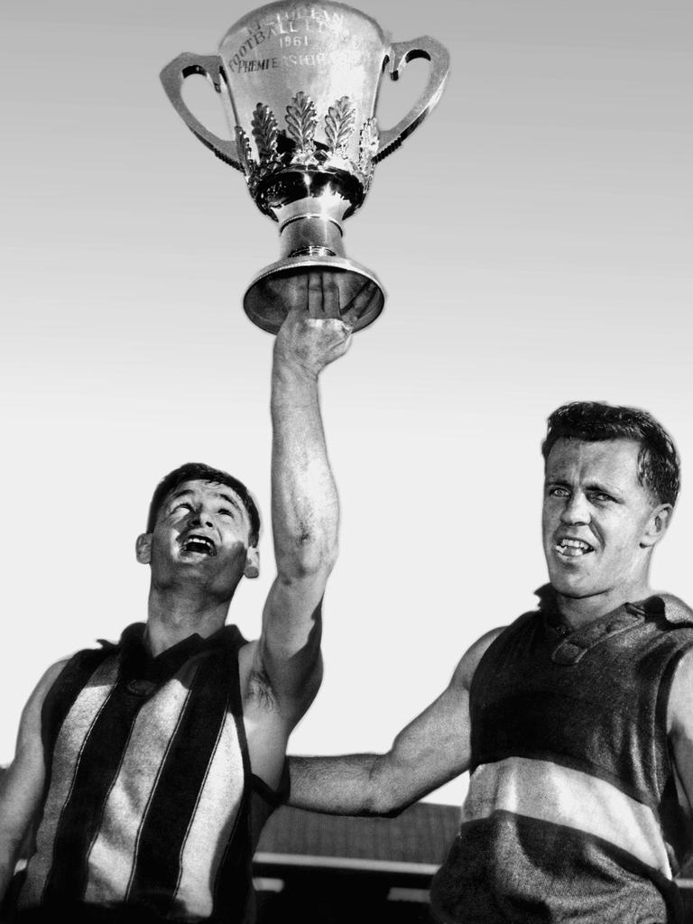 Arthur holds the 1961 premiership cup aloft, alongside Ted Whitten.