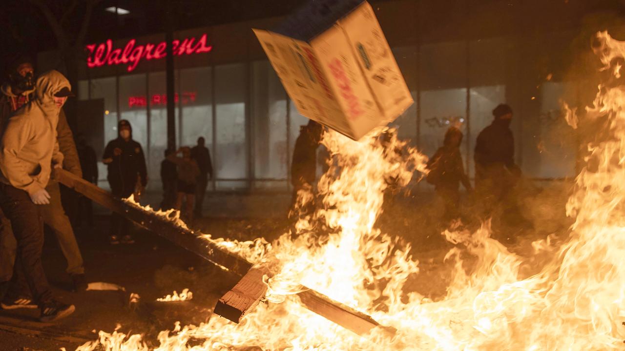 Protesters burning fires in the street in Oakland California. Picture: Ethan Swope/AP