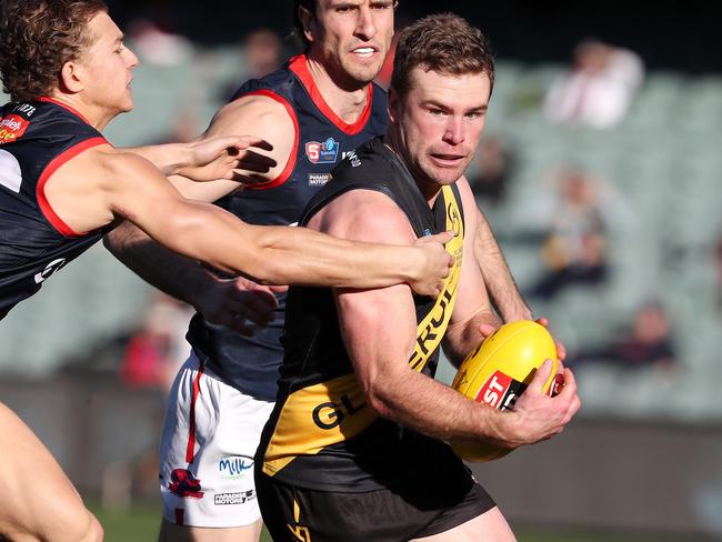 SANFL - 2nd match of a double header - Glenelg v Norwood at the Adelaide Oval. Tigers Andrew Bradley tries to get away from Norwood's Nick Pedro. Picture SARAH REED