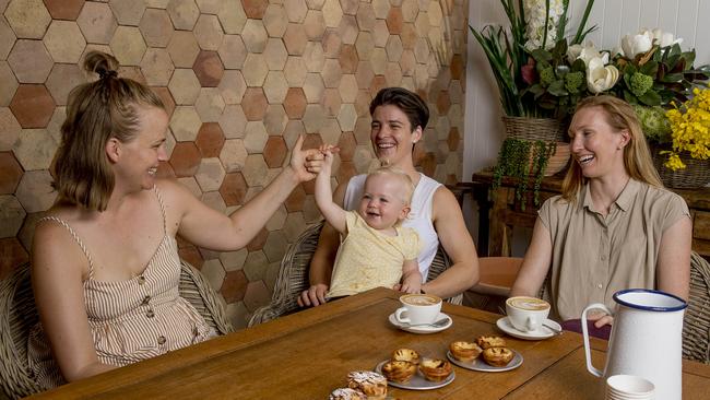 Jenna Vandyk (partner of Sam Virgo) with Gold Coast Suns AFLW players, Sam Virgo (holding Harriet Virgo, 1,) and Tiarna Ernst. Picture: Jerad Williams