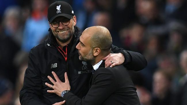 Even Jurgen and Pep are excited about this run of games. (AFP Photo / Paul Ellis)