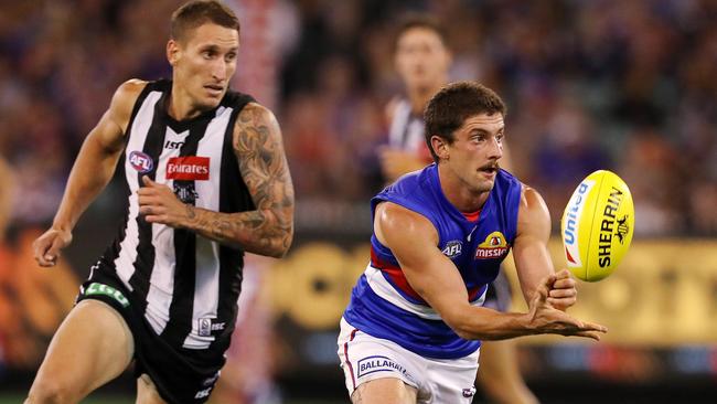 AFL Round 1. Collingwood vs. Western Bulldogs at the MCG. Tom Liberatore clears by hand .Pic : Michael Klein
