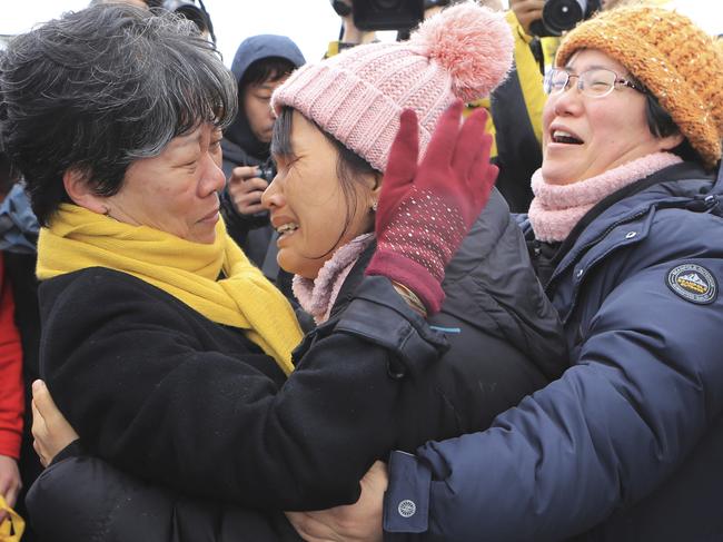 Relatives of missing passengers of the sunken ferry Sewol react as they watch the salvage operation under way in the waters off Jindo, South Korea, Saturday, March 25, 2017. Days after South Korean President Park Geun-hye was removed from office, the ferry was lifted slowly from the waters where it sank three years earlier - a disaster that killed more than 300 people, mostly schoolchildren, and ignited public fury against Park and became a nationally polarizing issue. (Lee Jin-wook/Yonhap via AP)