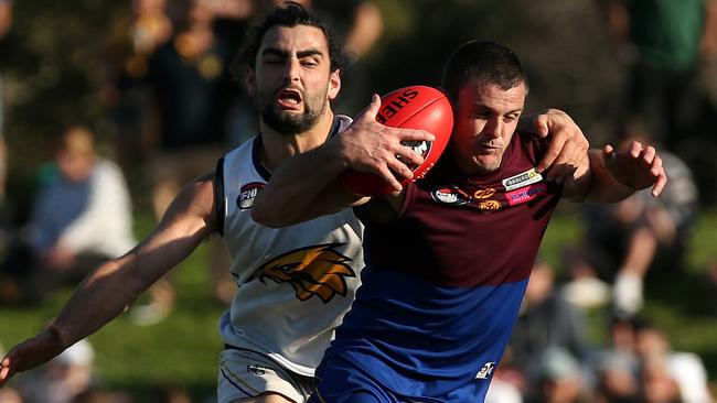 Brent Stanton is tackled by Xavier Dimasi. Picture: Hamish Blair