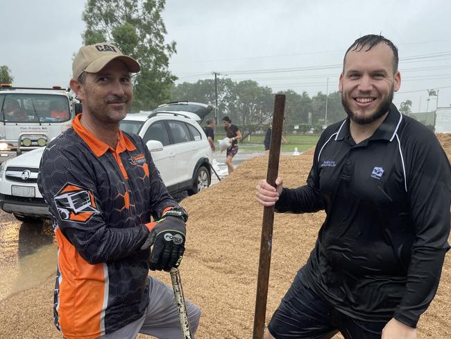 Kurt Sayed (left) from Townsville & Northern Beaches Trailer Hire was one of the first to start filling sandbags at the Mount Low, (right) division 2 councillor Brodie Phillips