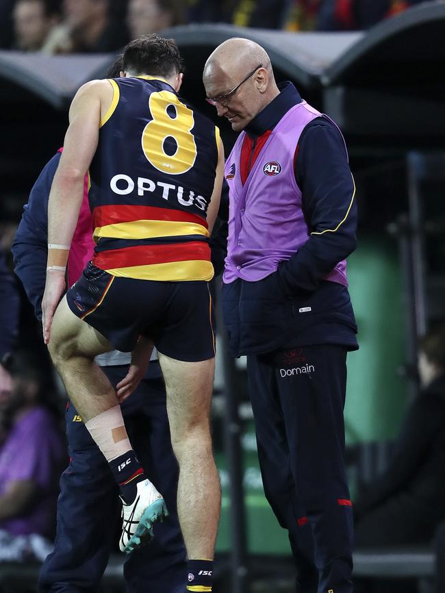 Jake Kelly with medical staff on the boundary looking at his left calf. Picture SARAH REED