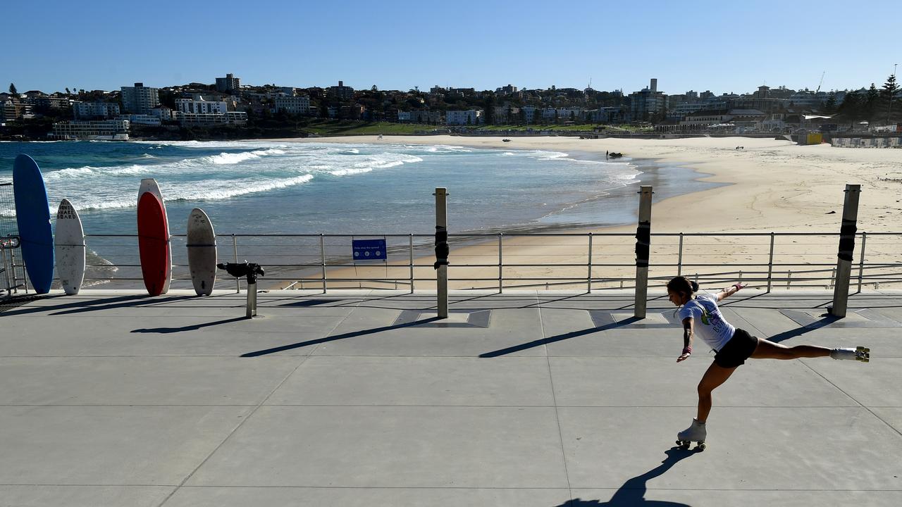 A woman rollerskates in front of a closed Bondi Beach in Sydney on Easter Sunday. Picture: Joel Carrett/AAP