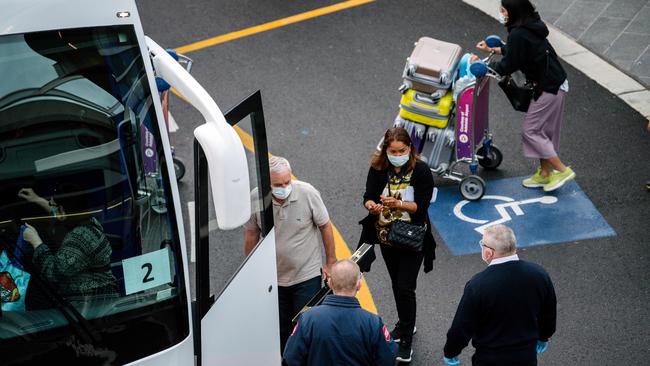 Passengers are loaded onto buses headed to the Pullman Hotel in Adelaide where they will quarantine for 14 days. Photo: The Advertiser/ Morgan Sette.