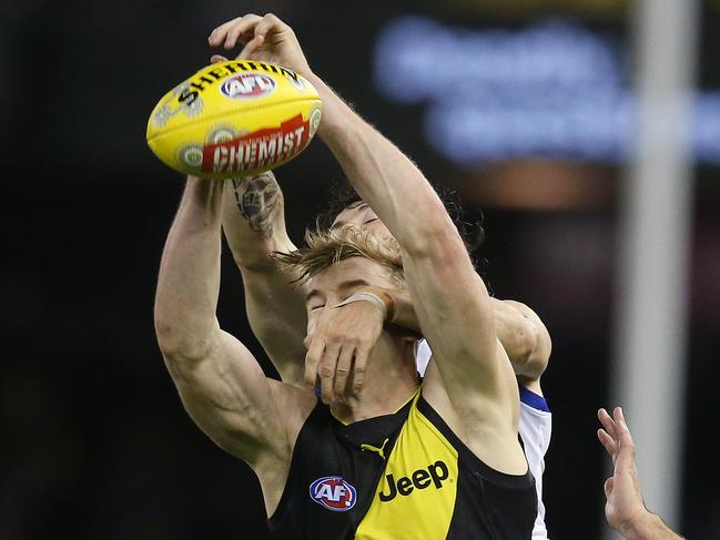 AFL Round 11. 31/05/2019.   North Melbourne v Richmond at Marvel Stadium.   Richmonds Tom Lynch  spoilt by Jasper Pittard of the Kangaroos 2nd quarter     . Pic: Michael Klein.