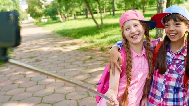 Cute photos with friends are one thing, but when your kid starts practising her duck face, it’s time to hide the selfie stick. (Pic: iStock)