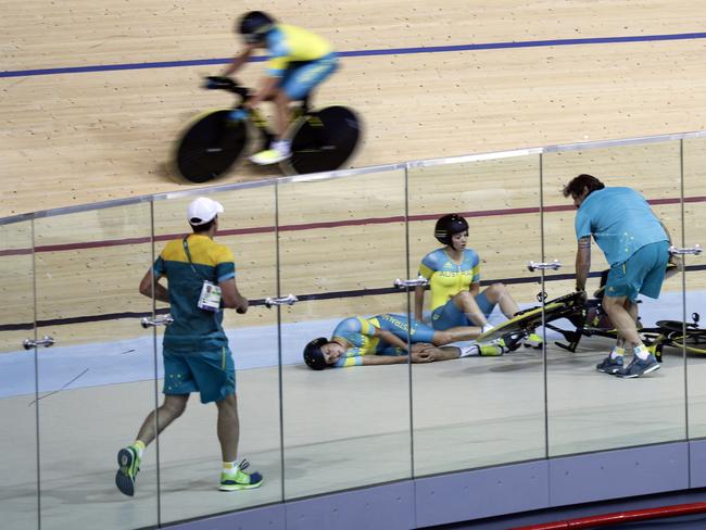 Melissa Hoskins, centre left, of the Australian women's track cycling team, reacts after crashing during a training session inside the Rio Olympic Velodrome during the 2016 Olympic Games in Rio de Janeiro, Brazil, Monday, Aug. 8, 2016.