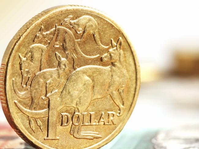 Aussie one dollar coins, on a twenty dollar note.