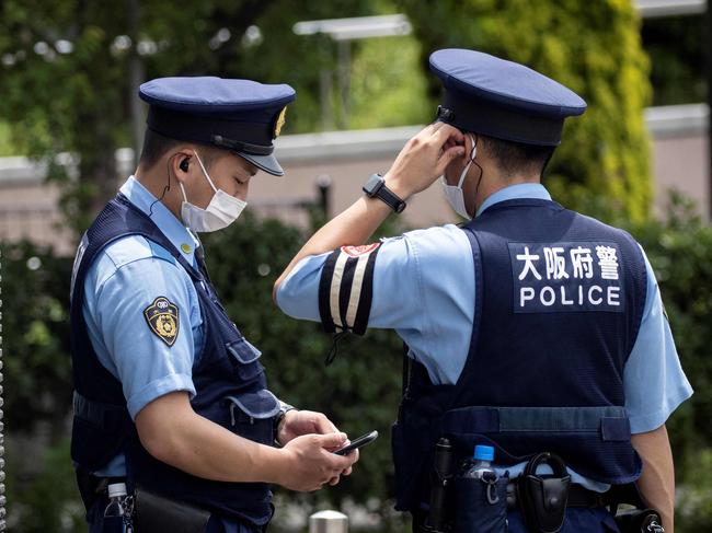 Police officers stand outside the Tokyo 2020 Olympic and Paralympic Village on July 14, 2021, ahead of the 2020 Tokyo Olympics which begin on July 23. (Photo by Behrouz MEHRI / AFP)