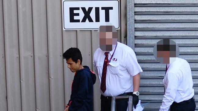 Numan Mohammed, left, is led into court for his first appearance. Picture: AAP / David Mariuz