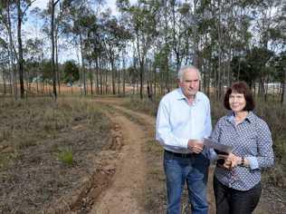 John and Kathryn Mahoney are disputing the government change made to their land in Deebing Heights. It has been changed from development purpose land to rural (with a lower value) despite development occurring on the property opposite (as seen behind). Picture: Rob Williams