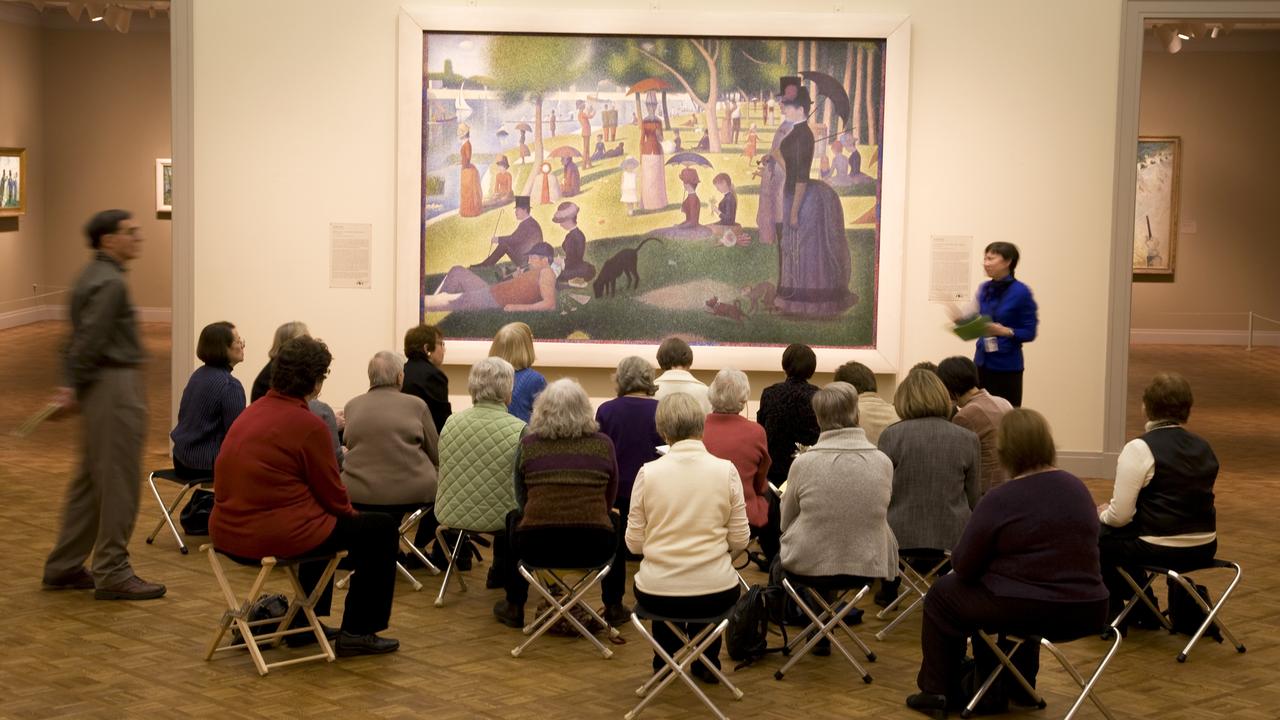 Mark Knight’s high school art teacher Ms Webster used to take the class to art galleries to sit in front of some of the world’s great paintings, much like this more senior tour group viewing the famous Georges Seurat painting A Sunday on La Grande Jatte (1884) at the Art Institute of Chicago. Picture: supplied/Seanna Cronin