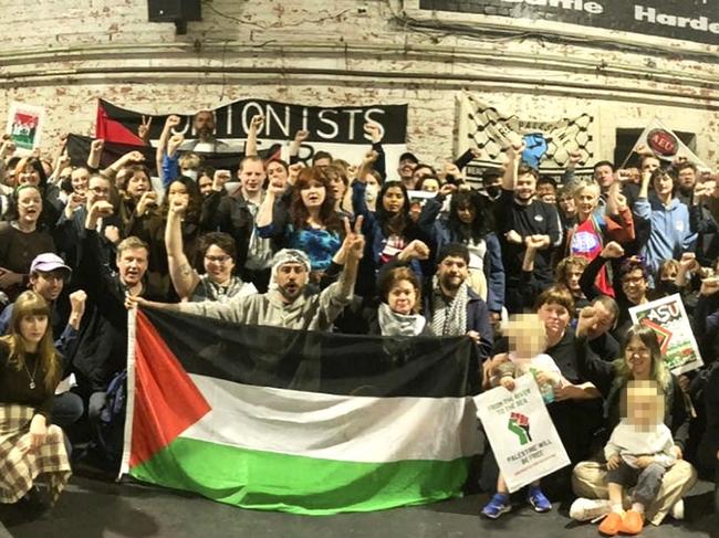 A meeting of trade unionists, with visible CFMEU branding, shows attendees posing with Palestinian flags.