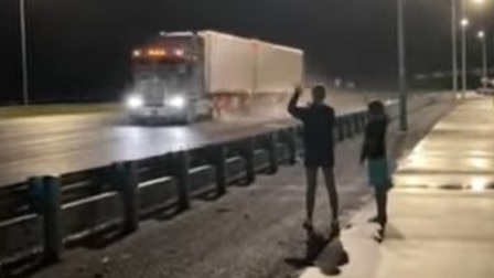 Residents in Gordonvale wave to trucks passing through on the way to Cairns in the early hours of Tuesday morning. Picture: Jaslyn Clarke