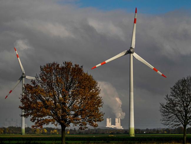 This picture taken on November 12, 2024 shows a wind turbine in front of the lignite-fired power station operated by German energy giant RWE near Neurath, western Germany. The 29th UN Climate Change Conference (COP 29) will take place in Azerbaijan from November 11 to November 22. At the 2015 climate conference in Paris, the international community agreed on the 1.5-degree target in order to avert a climate catastrophe (Photo by Ina FASSBENDER / AFP)