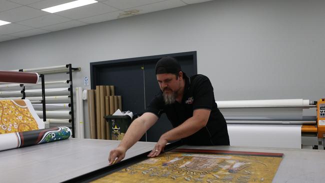 Sign writer Jarret Shardlow works on the hieroglyphic signage. Picture: Molly FrewPicture: Molly Frew