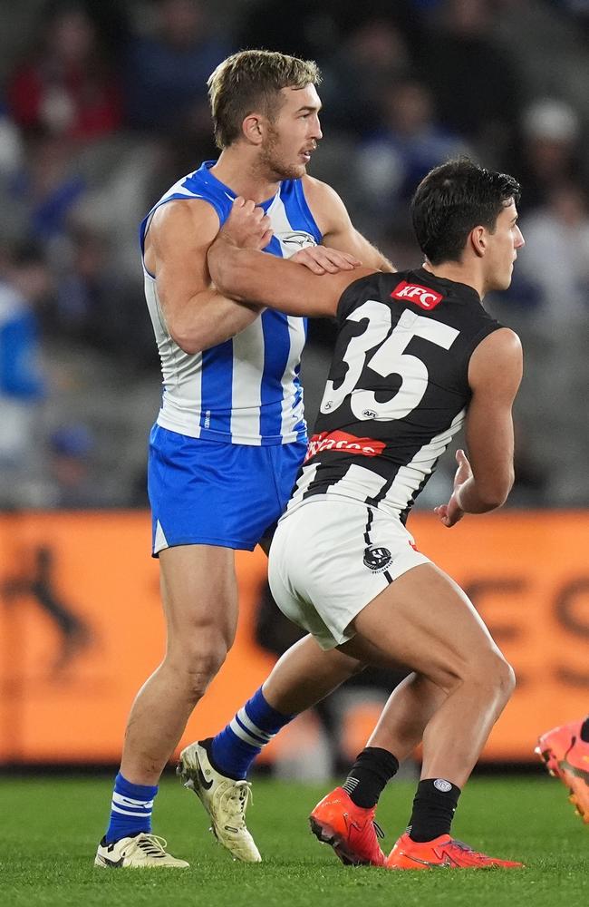Will Phillips of the Kangaroos and Nick Daicos of the Magpies compete at a stoppage. Picture: Daniel Pockett/Getty Images.