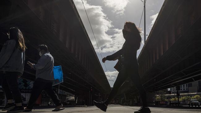 People wearing masks are seen exercising in South Melbourne. Picture: Getty