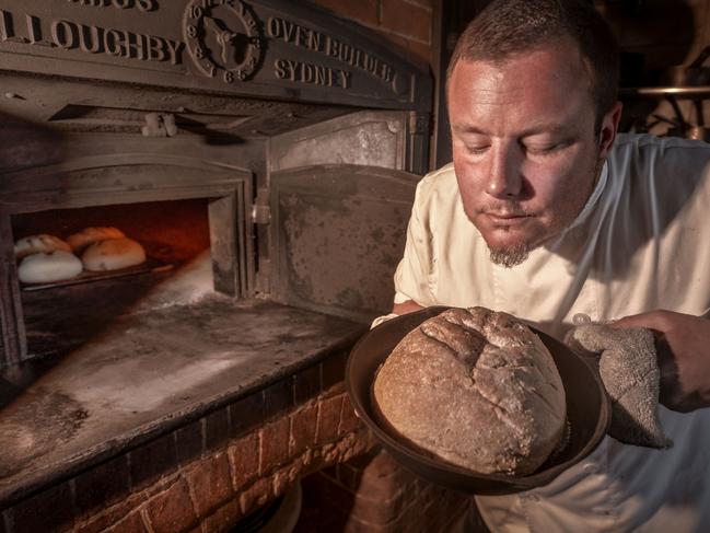 Vesta Consultant Chef Misha Laurent checks one of the loaves he has been baking in the antique wood-fired oven still in action today at the Blackheath restaurant.Photo: David Hill, Deep Hill Media.