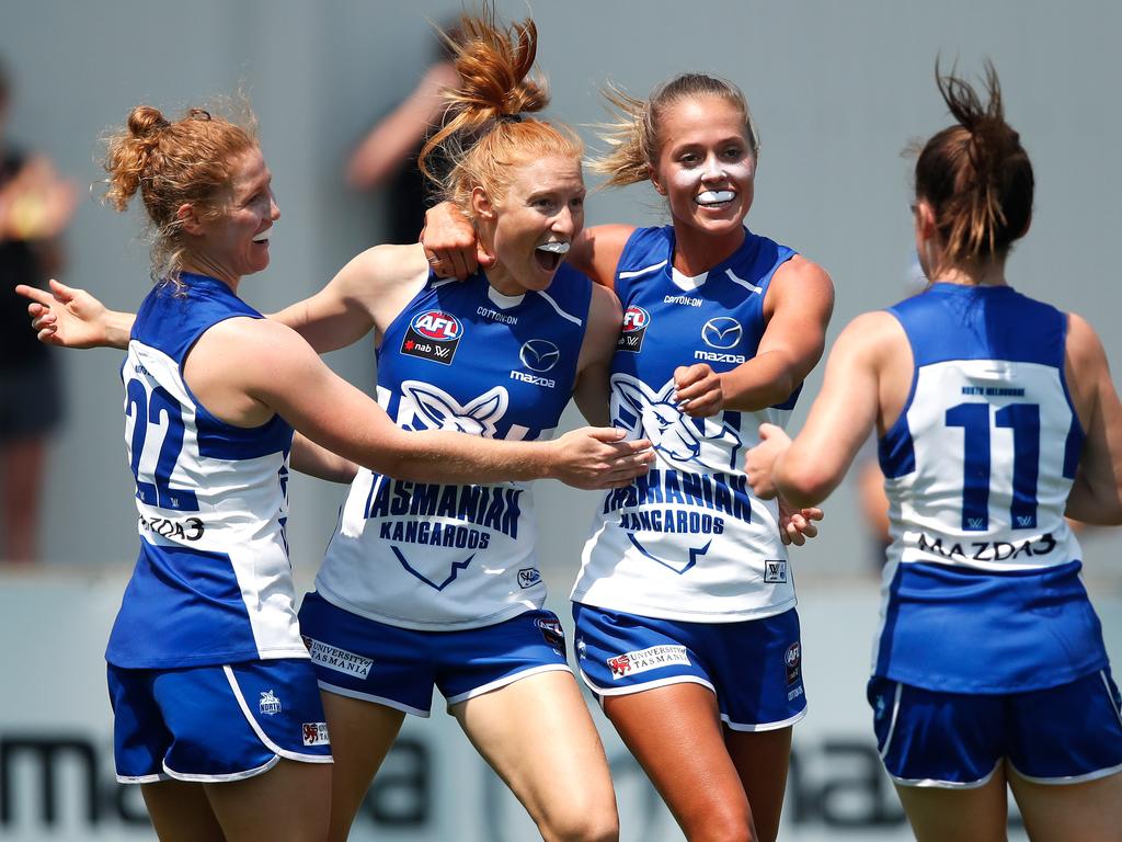 HOBART, AUSTRALIA - FEBRUARY 03: L-R Georgia Nanscawen, Alison Drennan, Kaitlyn Ashmore and Daisy Bateman of the Kangaroos celebrate during the 2019 NAB AFLW Round 01 match between the North Melbourne Tasmanian Kangaroos and the Carlton Blues at North Hobart Oval on February 03, 2019 in Hobart, Australia. (Photo by Adam Trafford/AFL Media/Getty Images)