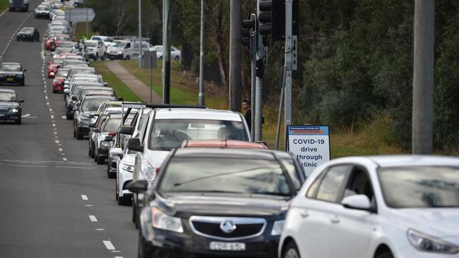 People queue in their cars for a COVID-19 test at a testing station at the Crossroads Hotel in Casula, southwest Sydney, on Monday. Picture: AFP