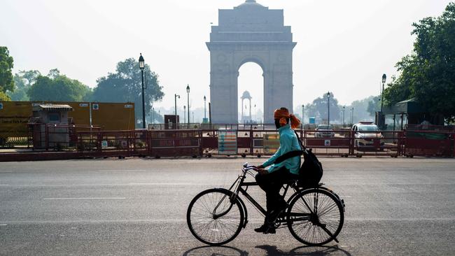 A man rides past the India Gate on a bicycle in New Delhi during a lockdown.