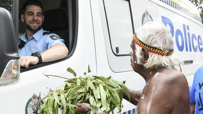 Constable Curtis Shuttleworth gets smoked by Uncle Max Eulo in Redfern. Picture: Darren Leigh Roberts.