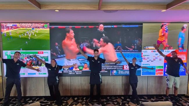 Twin City Hotel staff show off the massive screens available to watch the Melbourne Cup. Picture: Supplied.