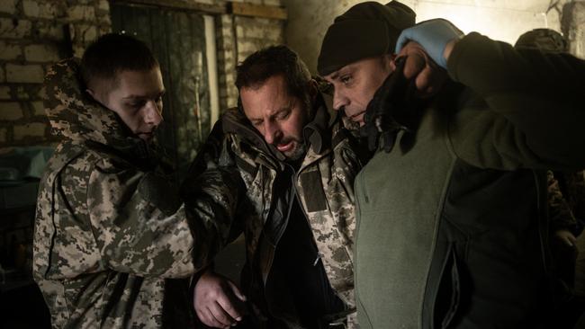 Military medics assist a Ukrainian troop to an ambulance outside Bakhmut after Russia launched a fresh wave of missile attacks on Monday. Picture: Getty Images