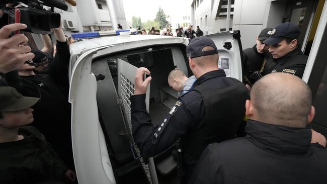Vadim Shishimarin of the Russian army is put into the back of a police van after being sentenced to life in prison. Picture: Getty Images